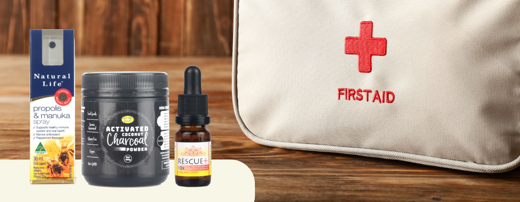 Propolis spray, activated charcoal and rescue plus bottle in front of first aid kit.